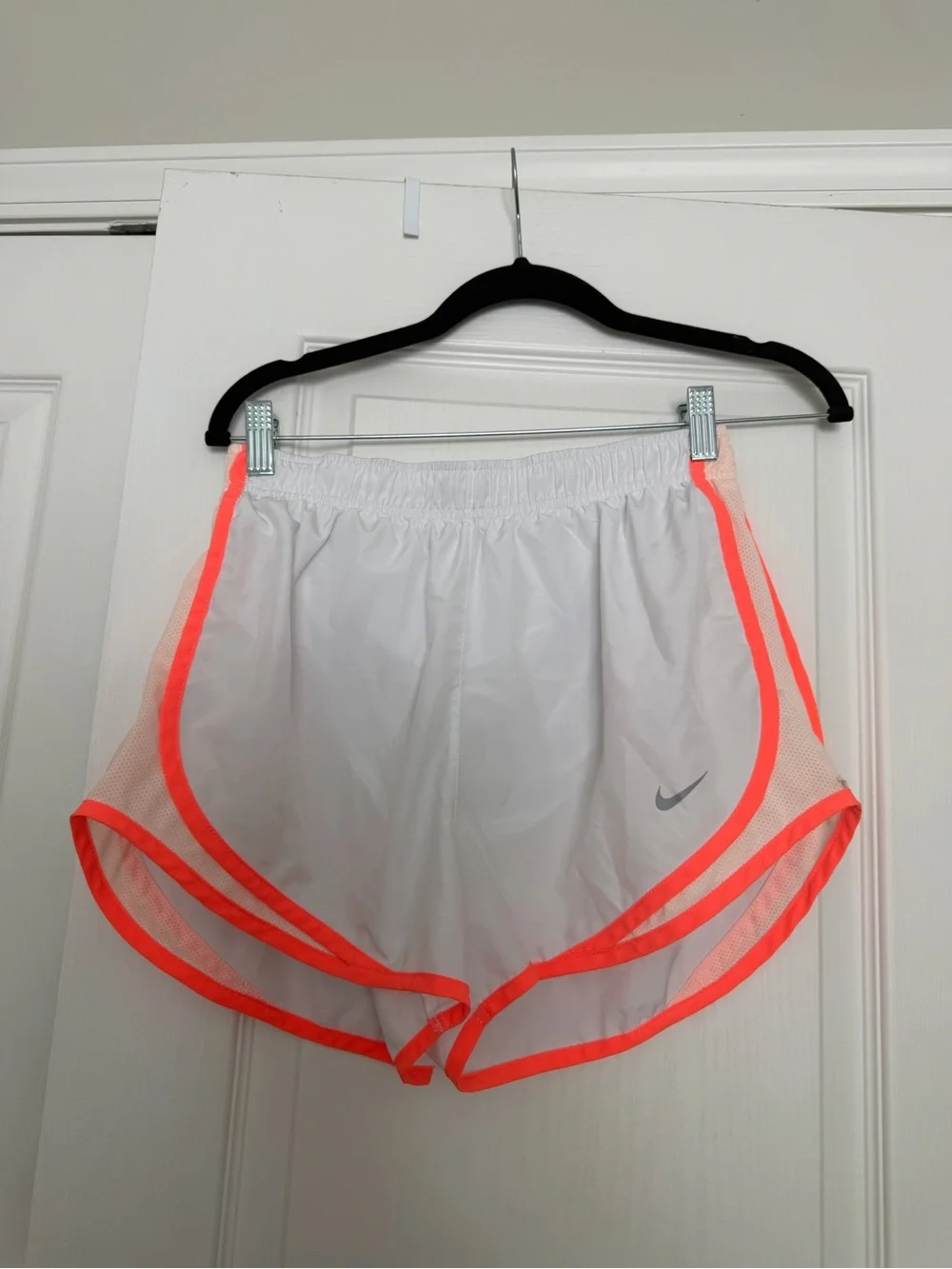 Nike Dri-Fit white running shorts with orange trim, size M